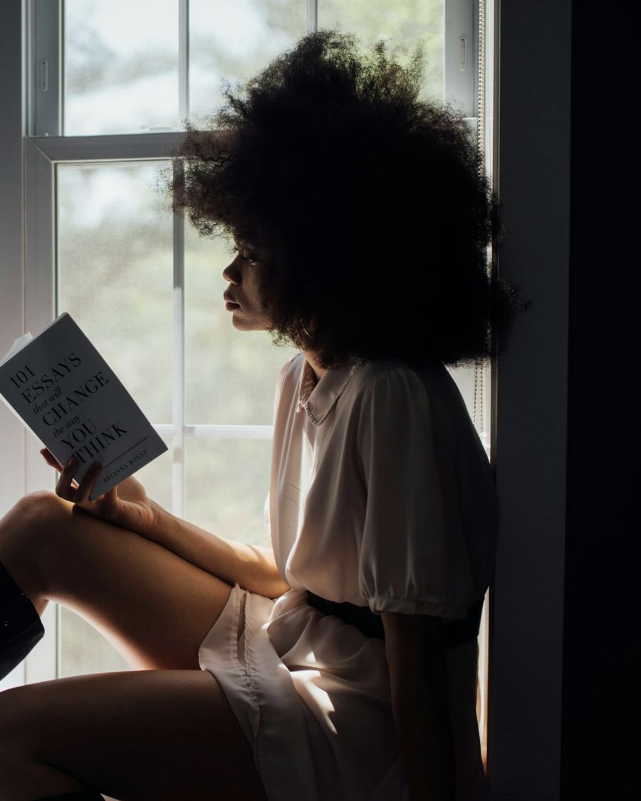 A woman reading on a window seat
